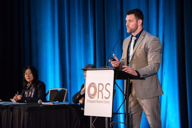 Dr. Behrens speaking at an orthopaedic research conference