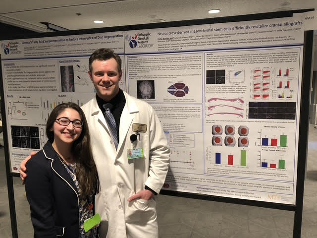 Dr. Behrens with a colleague in front of research posters